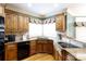 Kitchen showcasing wood cabinets, granite countertops, a sink with a window view and stainless steel appliances at 1038 Rolling Park Ln, Fort Mill, SC 29715