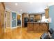 Kitchen featuring wood cabinets, stainless steel appliances, breakfast bar and an adjacent laundry room at 1038 Rolling Park Ln, Fort Mill, SC 29715