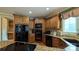 Modern kitchen with black appliances and corner sink at 1038 Rolling Park Ln, Fort Mill, SC 29715