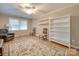 Bright living room featuring hardwood floors, built-in shelving, and a ceiling fan at 106 Fox Run Dr, Fort Mill, SC 29715