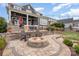 Landscaped backyard with stone patio and fire pit at 112 Sisters Cove Ct, Mooresville, NC 28117