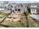 Aerial view of backyard with tiered landscaping, a patio, and an in-ground pool, perfect for entertaining at 112 Sisters Cove Ct, Mooresville, NC 28117