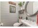 Powder room features a stylish sink, decorative mirror and shiplap walls at 112 Sisters Cove Ct, Mooresville, NC 28117