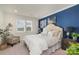 Bedroom with a blue accent wall and comfortable bed at 112 Sisters Cove Ct, Mooresville, NC 28117