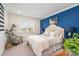 Bright bedroom with a serene blue accent wall and two sunny windows at 112 Sisters Cove Ct, Mooresville, NC 28117