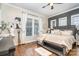 Comfortable bedroom featuring hardwood floors, a ceiling fan and a large window at 112 Sisters Cove Ct, Mooresville, NC 28117