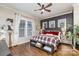 Main bedroom with hardwood floors, large windows, and ceiling fan at 112 Sisters Cove Ct, Mooresville, NC 28117