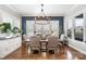 A spacious dining room with natural light, stylish chandelier, and hardwood floors at 112 Sisters Cove Ct, Mooresville, NC 28117