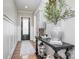 Elegant entryway with white wainscoting, hardwood floors, and stylish console table decor at 112 Sisters Cove Ct, Mooresville, NC 28117