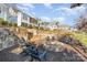 Stone fire pit with seating area, surrounded by landscaping at 112 Sisters Cove Ct, Mooresville, NC 28117