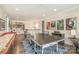 Entertainment room with a ping pong table, shuffleboard, hardwood floors and colorful artwork at 112 Sisters Cove Ct, Mooresville, NC 28117