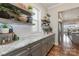 Gray kitchen cabinets and granite countertops, open shelving, and hardwood floors at 112 Sisters Cove Ct, Mooresville, NC 28117