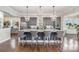 Large granite kitchen island with seating and modern lighting in an open concept space at 112 Sisters Cove Ct, Mooresville, NC 28117