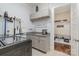 Laundry room with built-in cabinets, sink, and storage at 112 Sisters Cove Ct, Mooresville, NC 28117