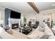 Elegant living room featuring a stone fireplace, plush seating, and an open floor plan at 112 Sisters Cove Ct, Mooresville, NC 28117