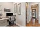 Home office with granite countertop desk and built-in shelving at 112 Sisters Cove Ct, Mooresville, NC 28117