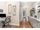 Office nook with modern desk, granite counters, hardwood floors and natural light at 112 Sisters Cove Ct, Mooresville, NC 28117