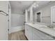 Bathroom with double vanity, tub shower combo, and light wood-look floors at 1308 Carmel Rd, Lancaster, SC 29720