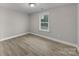 Bright bedroom with wood-look floors and large window at 1308 Carmel Rd, Lancaster, SC 29720