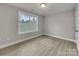 Bedroom with wood-look floors and a window at 1308 Carmel Rd, Lancaster, SC 29720