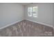 Cozy bedroom with neutral walls and carpeted floors at 267 Elm Nw Ave, Concord, NC 28025