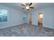 Spacious bedroom with ceiling fan and plush carpeting at 267 Elm Nw Ave, Concord, NC 28025