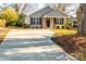 Gray house with a covered porch, brick columns, and black shutters at 267 Elm Nw Ave, Concord, NC 28025