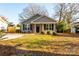 Gray house with a covered porch, brick columns, and black shutters at 267 Elm Nw Ave, Concord, NC 28025