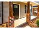 Black front door with brick columns and wood accents at 267 Elm Nw Ave, Concord, NC 28025