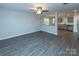 Spacious living room with gray vinyl flooring and a ceiling fan at 267 Elm Nw Ave, Concord, NC 28025