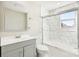 This remodeled bathroom has a shower-tub with custom tile, a gray vanity and updated fixtures at 287 Young Sw Ave, Concord, NC 28025