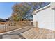 A wooden deck with railings offers a great view of the neighborhood and surrounding trees at 287 Young Sw Ave, Concord, NC 28025