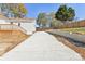 Long concrete driveway leads to the home, complemented by a wooden deck and fenced yard at 287 Young Sw Ave, Concord, NC 28025