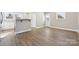 Open-concept living room with hardwood floors, neutral walls, and lots of space for furniture at 287 Young Sw Ave, Concord, NC 28025