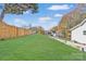 A sprawling green yard is enclosed by a tall, wooden privacy fence at 287 Young Sw Ave, Concord, NC 28025