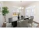 Elegant dining room with a stylish table, modern lighting fixture, and view to the outdoors at 833 River Park Rd, Belmont, NC 28012