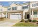 Inviting townhouse exterior with stone accents, two-car garage, and well-manicured lawn at 833 River Park Rd, Belmont, NC 28012