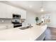 Contemporary kitchen featuring stainless steel appliances, gray backsplash, and a sleek white countertop at 833 River Park Rd, Belmont, NC 28012