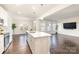 Open concept living room and kitchen with island, hardwood floors, and large windows at 833 River Park Rd, Belmont, NC 28012