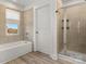 Bathroom with bathtub, shower, and tile flooring at 12502 Stonebriar Ridge Dr, Davidson, NC 28036