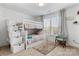 Bedroom with a white bunk bed, window seating, and ample natural light at 12502 Stonebriar Ridge Dr, Davidson, NC 28036