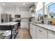 Modern kitchen with white cabinets, granite countertops, and stainless steel appliances at 12502 Stonebriar Ridge Dr, Davidson, NC 28036