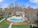 Community pool and clubhouse with outdoor grilling area at 12502 Stonebriar Ridge Dr, Davidson, NC 28036