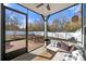 Relaxing screened porch with wicker furniture and a view of the backyard at 12502 Stonebriar Ridge Dr, Davidson, NC 28036