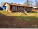Spacious backyard with a brick exterior, patio, and mature trees, offering great outdoor living potential at 2040 Ne 25Th Street Dr, Hickory, NC 28601