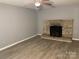 Living room featuring a stone fireplace, gray walls, and new flooring at 2040 Ne 25Th Street Dr, Hickory, NC 28601