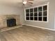 Bright living room featuring a stone fireplace, ceiling fan, and new flooring at 2040 Ne 25Th Street Dr, Hickory, NC 28601