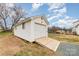 White storage shed with a wooden ramp for easy access at 3600 Parkwood School Rd, Monroe, NC 28112