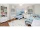 Charming bedroom with twin beds, ocean mural, bright windows, and cozy decor, creating a playful space at 5431 Park Rd, Charlotte, NC 28209