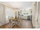 Light-filled dining area featuring a wooden table and updated lighting fixture at 5431 Park Rd, Charlotte, NC 28209